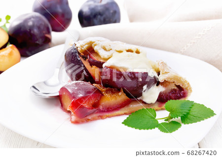 Galeta with plums in plate on light table Galeta with plums in plate on light table 68267420
