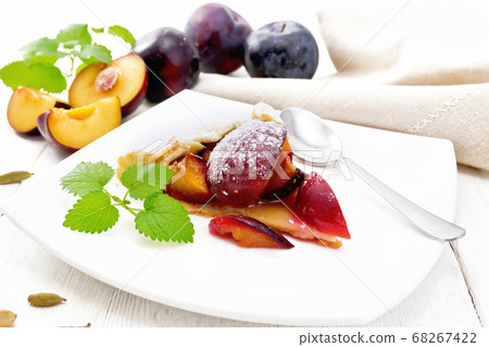 Galeta with plums in plate on white board Galeta with plums in plate on white board 68267422