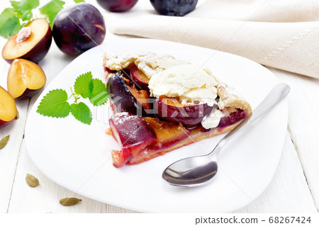Galeta with plums in plate on wooden table Galeta with plums in plate on wooden table 68267424