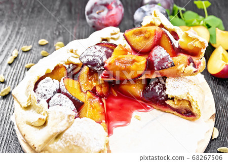 Galeta with plums on dark wooden board 68267506