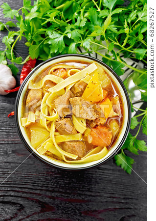 Lagman in bowl on dark board top 68267527