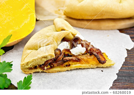 Pie with pumpkin and fried onions on board 68268019