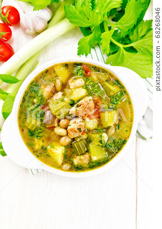 Soup with pisto sauce in bowl on light board top 68268046