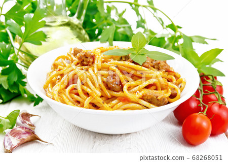 Spaghetti with bolognese in plate on wooden board Spaghetti with bolognese in plate on wooden board 68268051