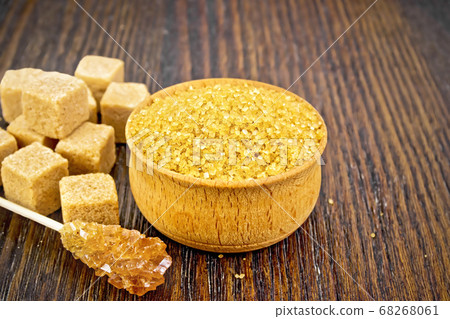 Sugar brown in wooden bowl on board Sugar brown in wooden bowl on board 68268061