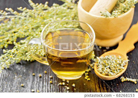 Tea of gray wormwood in glass cup with mortar Tea of gray wormwood in glass cup with mortar 68268153