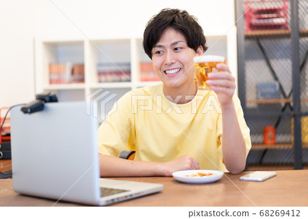 Online drinking party Young men drinking beer Online drinking party Young men drinking beer 68269412
