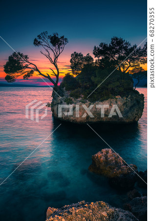 Small rocky island in the sea at sunset, Brela, Croatia Small rocky island in the sea at sunset, Brela, Croatia 68270355