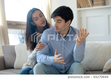 Loving young guilty woman trying making peace with angry guy. Loving young guilty woman trying making peace with angry guy. 68270694