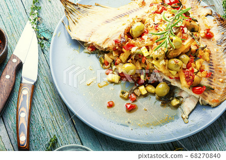Roasted fish and vegetables on wooden table 68270840