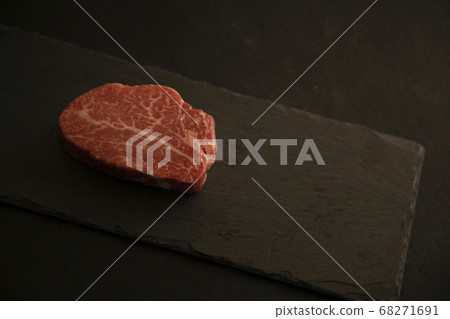 Raw beef fillet steak on black slate on black background 68271691