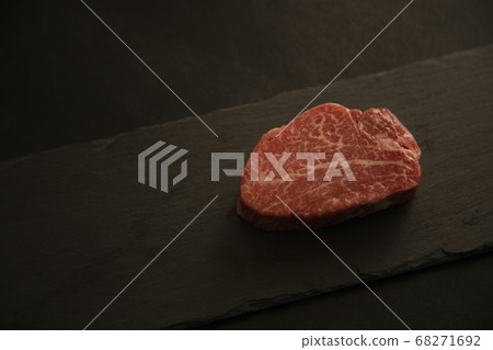 Raw beef fillet steak on black slate on black background 68271692
