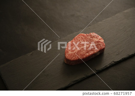 Raw thick beef fillet steak on black slate plate 68271957