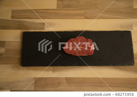 Raw thick beef fillet steak on black slate plate 68271958