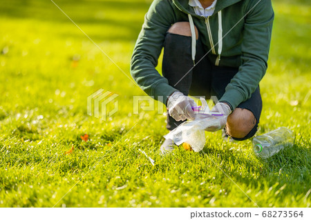 Low section of man cleaning park on sunny day Low section of man cleaning park on sunny day 68273564
