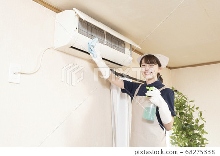 Female worker cleaning the house to clean the air conditioner Female worker cleaning the house to clean the air conditioner 68275338