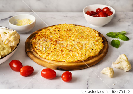 Healthy cauliflower pizza crust with ingrediets on white background Healthy cauliflower pizza crust with ingrediets on white background 68275360