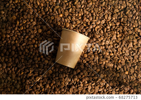 Pile of fresh aromatic coffee beans and paper mockup cup. Pile of fresh aromatic coffee beans and paper mockup cup. 68275713