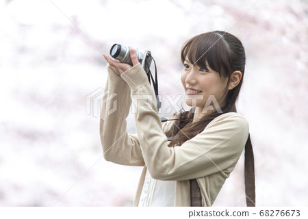 A woman shooting a cherry tree 68276673