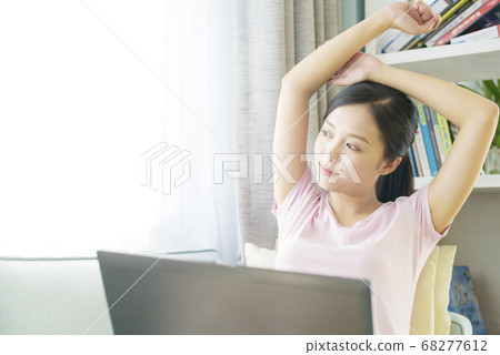 A woman who operates a personal computer at home A woman who operates a personal computer at home 68277612