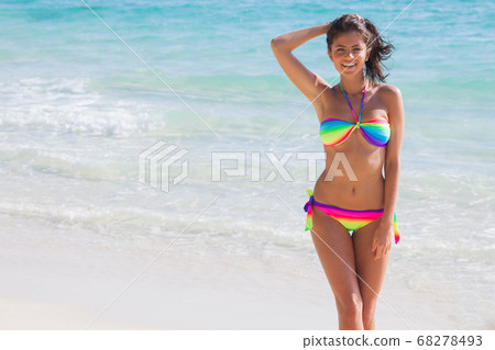 Girl in rainbow bikini at seaside Girl in rainbow bikini at seaside 68278493