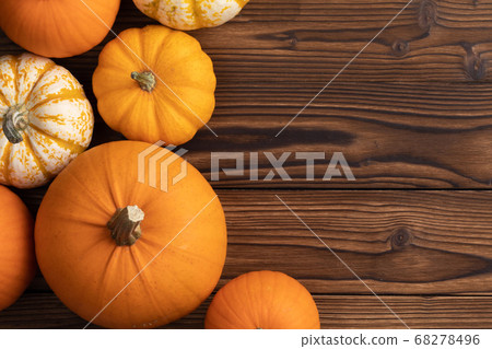 Border of pumpkins on wood background Border of pumpkins on wood background 68278496