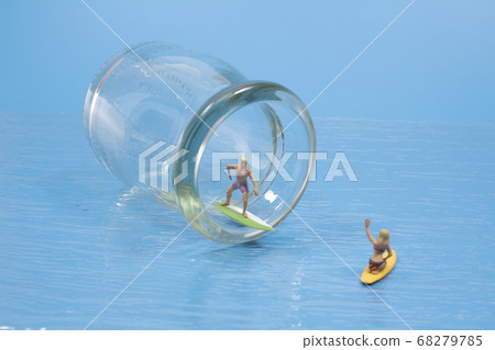 A Young surfers figure on the bottle, the waves A Young surfers figure on the bottle, the waves 68279785