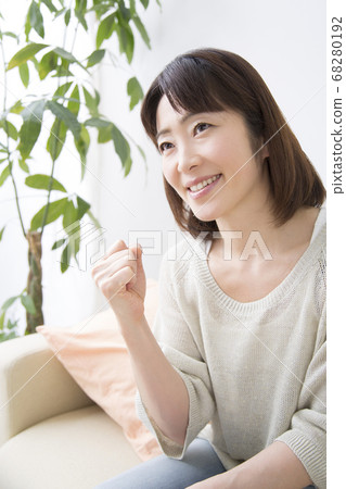 A middle woman who makes a guts pose A middle woman who makes a guts pose 68280192