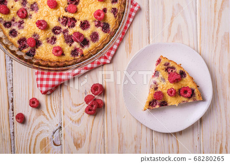 Sweet tasty pie with jellied and fresh raspberry fruits in baking dish and plate Sweet tasty pie with jellied and fresh raspberry fruits in baking dish and plate 68280265