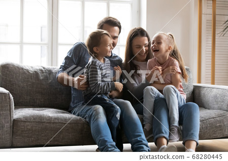 Joyful young parents having fun with little laughing children. Joyful young parents having fun with little laughing children. 68280445