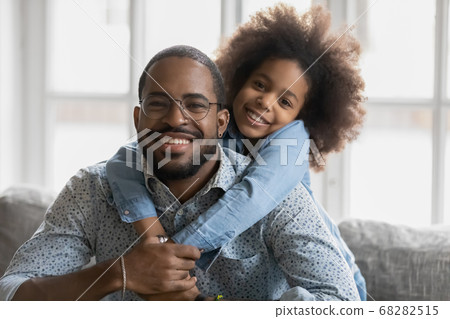 Portrait of happy african american dad and daughter cuddling 68282515