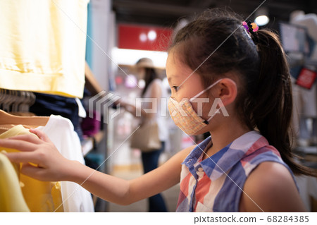 A girl choosing clothes A girl choosing clothes 68284385