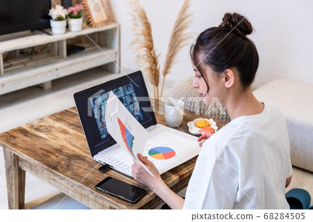 Woman attending an online meeting at home Woman attending an online meeting at home 68284505