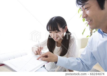 Daughter studying and father teaching 68284874