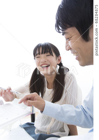 Daughter studying and father teaching 68284875