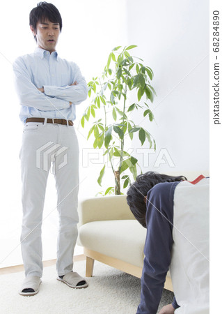 Father scolding his son 68284890
