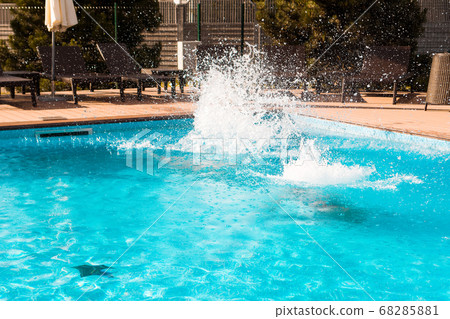 Pool fun. Jumping into the outdoor swimming pool 68285881