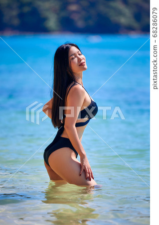 Close up portrait of beautiful asian woman in tropical outfit posing on the  beach. 32630369 Stock Photo at Vecteezy