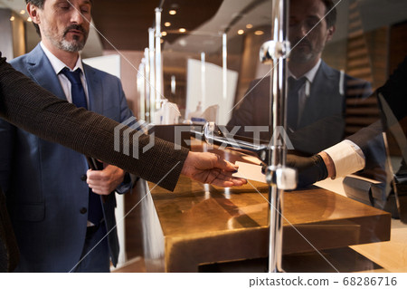 Couple paying by credit card in the modern hotel Couple paying by credit card in the modern hotel 68286716