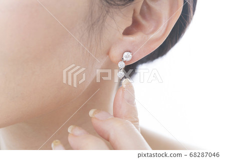 A woman with a pierced earring A woman with a pierced earring 68287046