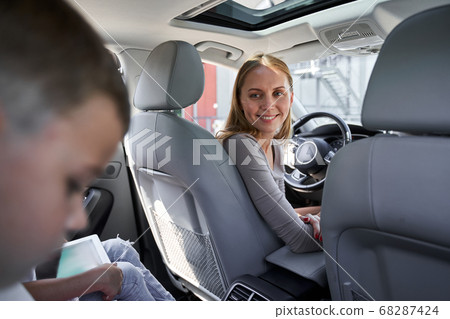 Kids travelling with gadgets and mom in car 68287424