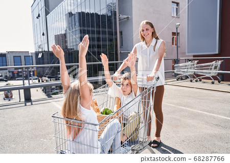 Happy two kids having fun with mother on shopping 68287766