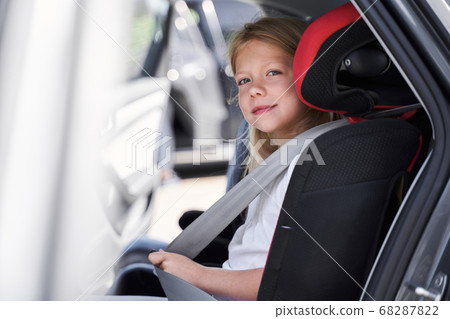 Smiling beautiful child in automobile safety seat Smiling beautiful child in automobile safety seat 68287822