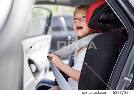 Cheerful girl ready for travelling by car Cheerful girl ready for travelling by car 68287824