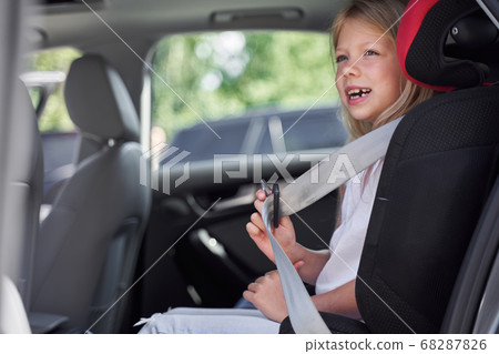 Happy little girl travelling in car seat Happy little girl travelling in car seat 68287826