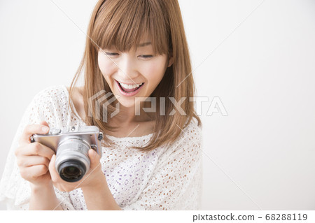 A woman taking a picture 68288119