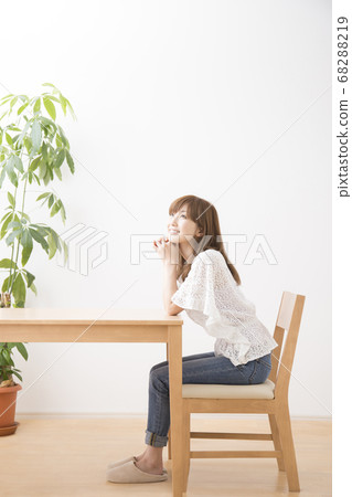Woman sitting on chair Woman sitting on chair 68288219