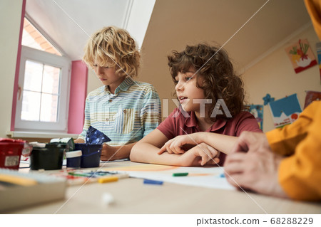Cheerful cute kids using paints at lesson Cheerful cute kids using paints at lesson 68288229