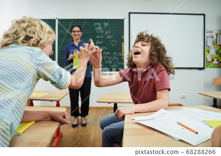 Jolly boys having fun during english lesson Jolly boys having fun during english lesson 68288266