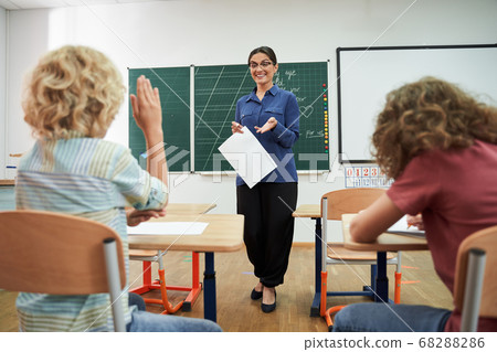 Happy teacher enjoying studies with cute boys Happy teacher enjoying studies with cute boys 68288286